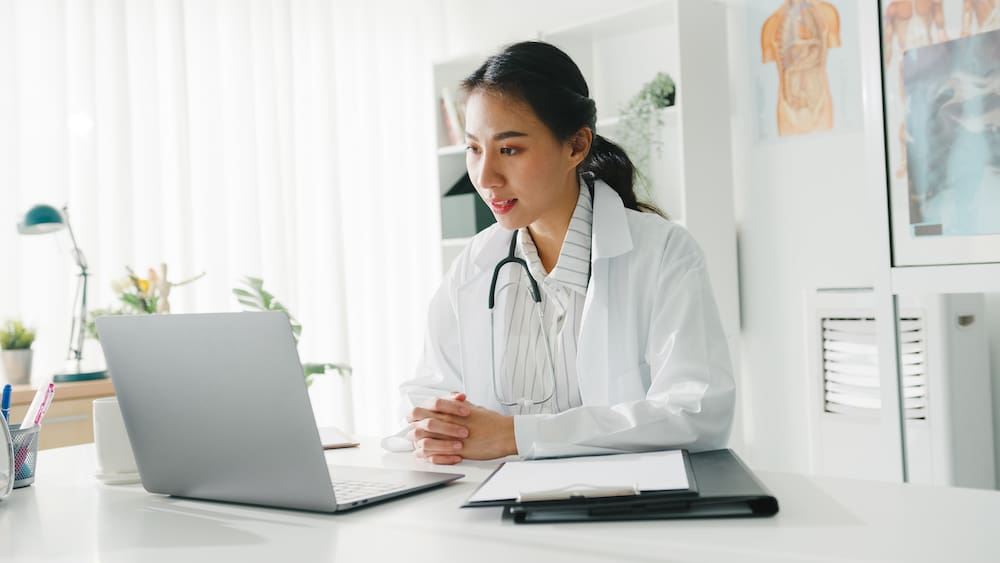 Asian female doctor using laptop for telehealth appointment